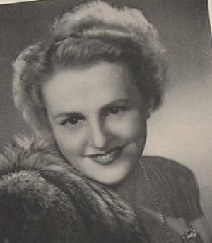 A portrait of Mary Bothwell. She is wearing a fur stole, red lipstick, and is smiling at the camera.