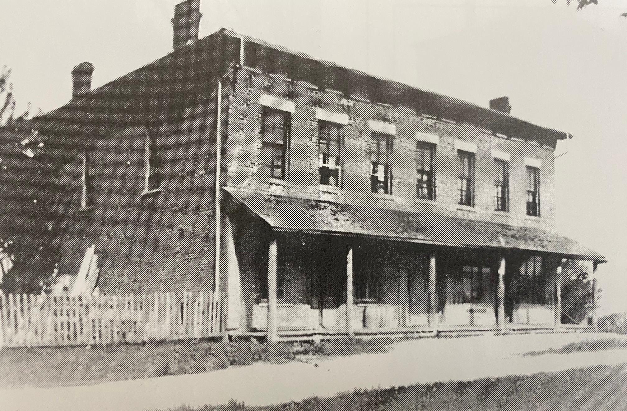 A black and white photograph of the store built by Mr. Morrow in Ratho in 1857. The store was in a two-storey brick building.