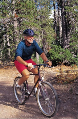 man riding his bike through trail