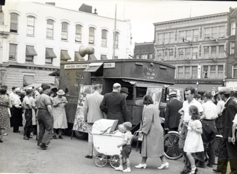 A crowd gathered around a tea car.